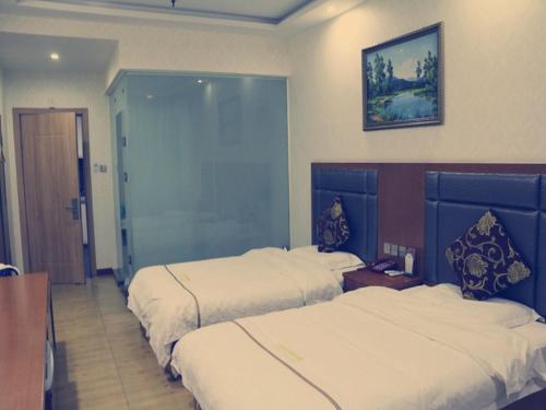 a hotel room with two beds and a mirror at Thank Inn Chain Hotel shanxi yulin yuyang district railway station in Yulin