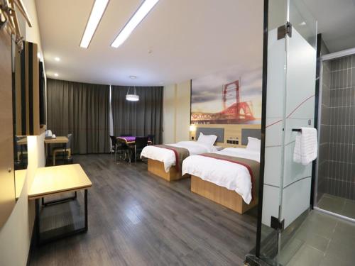a hotel room with two beds and a bathroom at Thank Inn Chain Hotel Xiangyang east railway station in hubei province in Xiangyang