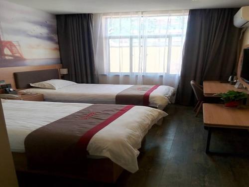 a hotel room with two beds and a desk at Thank Inn Chain Hotel Jiangsu xuzhou gulou DaHuangShan in Xuzhou