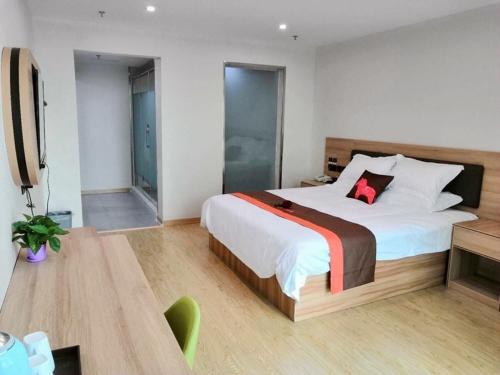 1 dormitorio con cama grande y mesa de madera en Thank Inn Chain Hotel jiangsu xuzhou jiawang district biantang county en Xuzhou