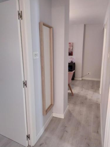 an empty room with a mirror and a hallway at La Parada de Echegaray in Zaragoza