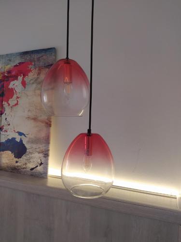two glass light bulbs hanging from a ceiling at La Parada de Echegaray in Zaragoza
