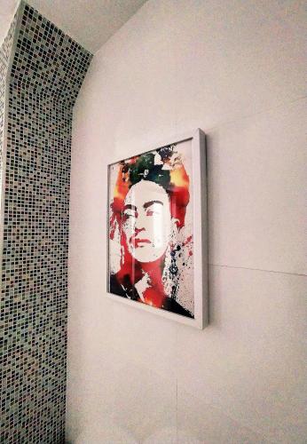 a painting of a woman on a wall in a bathroom at La Parada de Echegaray in Zaragoza