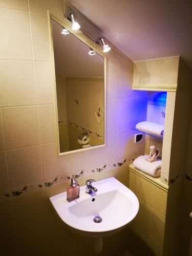 a bathroom with a sink and a mirror at Pensjonat Błękitny Anioł in Kiersztanowo