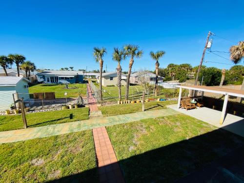 a backyard with palm trees and a playground at A 1 A Super Inn in Ormond Beach