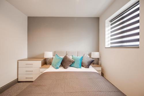 a bedroom with a large bed with blue pillows at Your Perfect Ashford Retreat Pet-Friendly & Business Ready in Ashford