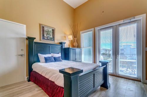 a bedroom with a bed and a large window at Inn at Gulf Place in Santa Rosa Beach