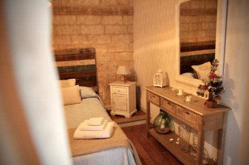 a small bedroom with a bed and a sink at La Stanza in Bari