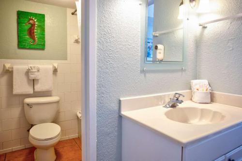 a bathroom with a white sink and a toilet at 513 - Island Inn in St. Pete Beach