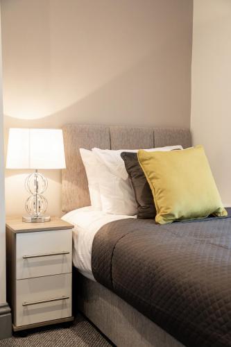 a bedroom with a bed with a night stand with a lamp at Your Perfect Ashford Retreat Pet-Friendly & Business Ready in Ashford