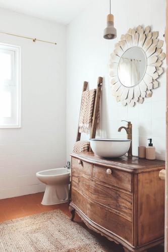 a bathroom with a sink and a toilet and a mirror at Casa de campo Villares in Dosbarrios