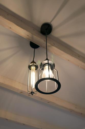 two lights are hanging from a ceiling at Afrodite Luxury Rooms in Telendos