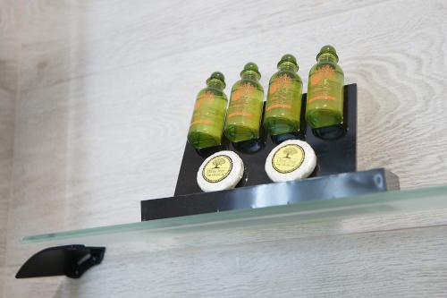 a group of green bottles sitting on a shelf at Afrodite Luxury Rooms in Telendos
