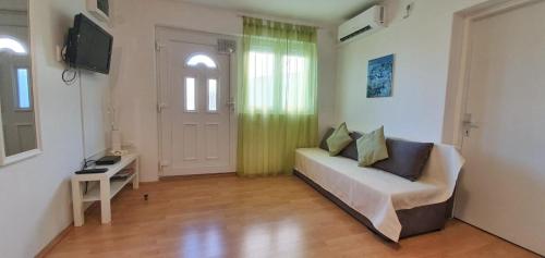a living room with a couch and a television at Apartment Mare in Crikvenica