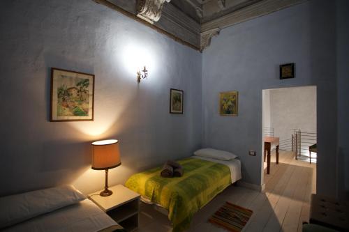 a bedroom with a bed and a lamp and a table at The Piano Nobile in Montepulciano