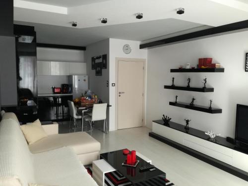 a living room with a white couch and a table at Apartment 33 in Hotel Iceberg in Borovets