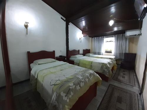 Ένα ή περισσότερα κρεβάτια σε δωμάτιο στο Gallardin Palace Hotel