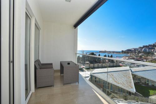 an apartment balcony with a view of the ocean at Apartments Menuet in Budva