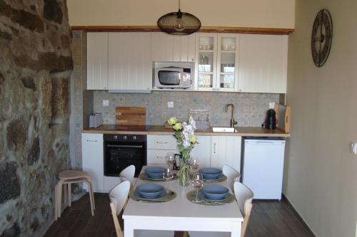 a kitchen with a table with blue dishes on it at Quinta do Sobrado in Braga