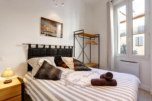 a bedroom with a large bed with towels on it at LE SAINT JOSEPH - Old tow, 2 appartments in 1 in Nice