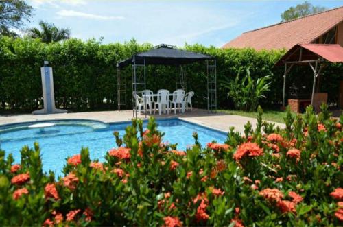 a swimming pool with chairs and a gazebo at Finca el Lunar in Honda