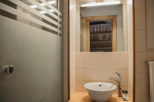 a bathroom with a white sink and a mirror at PR Campanas de San Juan in Santiago de Compostela