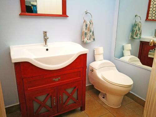a bathroom with a sink and a toilet at Hotel Casa 69 in San José