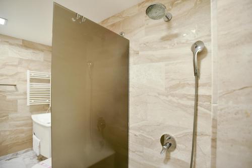 a shower with a glass door in a bathroom at Apartments Menuet in Budva