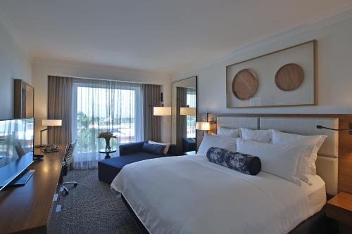 a hotel room with a large bed and a desk at Real Intercontinental Metrocentro Managua by IHG in Managua