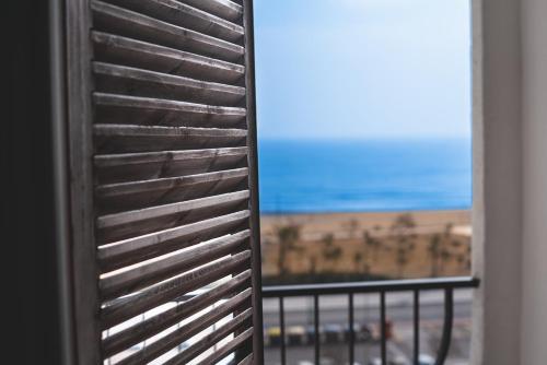 a window with a view of the beach at Ampuries Delta Apartment in Empuriabrava
