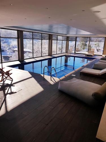 a large swimming pool in a large building at Mylaon Boutique Hotel & Spa in Vitina