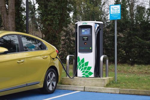 a yellow car parked next to a self charging machine at Holiday Inn Express Birmingham Airport NEC by IHG in Bickenhill