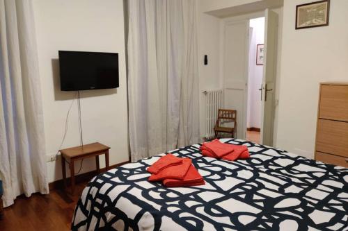 a bedroom with a bed with red pillows on it at Lanza Tomasi Apartment - centre in Rome