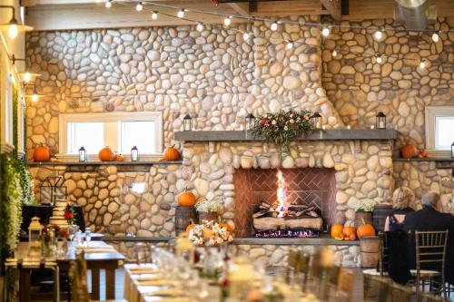 a stone wall with a fireplace in a restaurant at Holiday Inn Manahawkin/Long Beach Island by IHG in Manahawkin