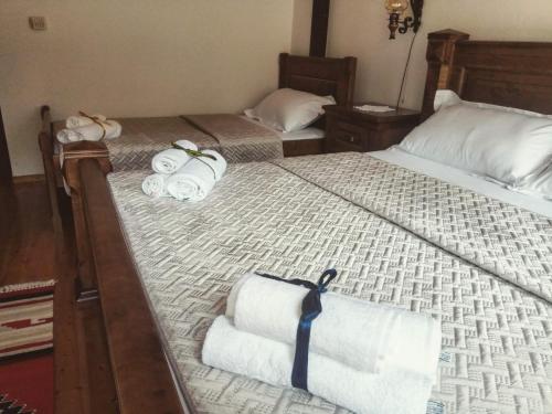 a bedroom with two beds with towels on them at Timo's Guest House in Berat
