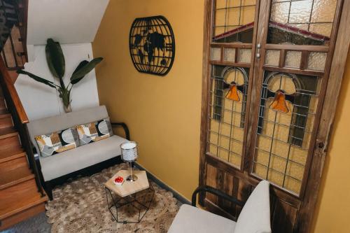 a room with a chair and a cabinet with stained glass windows at PR Campanas de San Juan in Santiago de Compostela