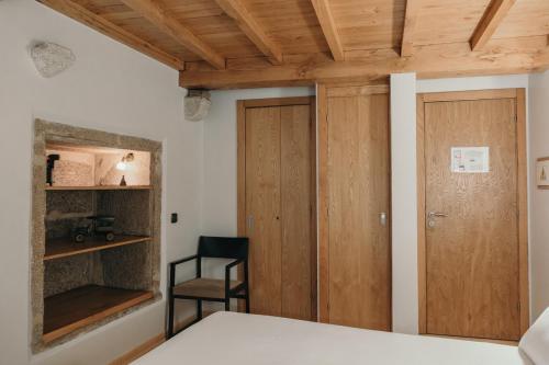 a bedroom with a bed and a wooden ceiling at PR Campanas de San Juan in Santiago de Compostela