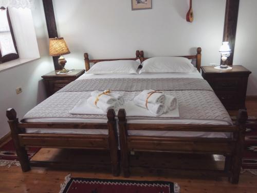 a bed with two pillows on it in a bedroom at Timo's Guest House in Berat