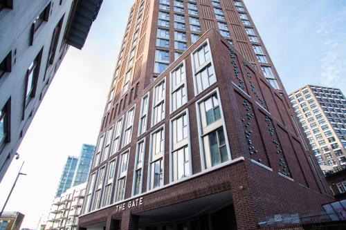a tall red brick building in a city at The Gate London City in London