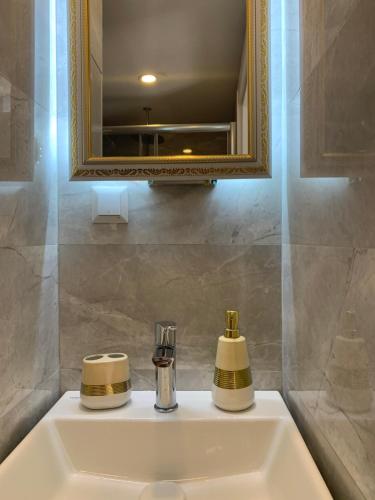 a bathroom sink with a mirror and a sink at Fatma Sultan Oldtown Konak & Restaurant in Antalya