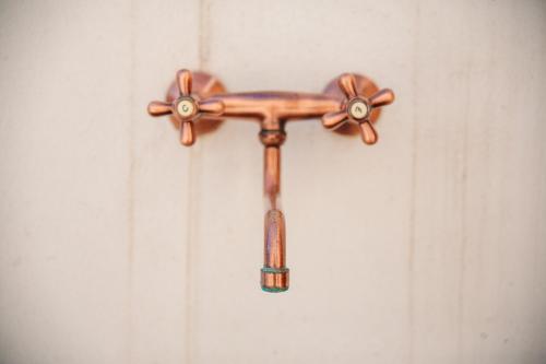 a wooden cross hanging on a white wall at Iolanda Vacanze in Lucugnano