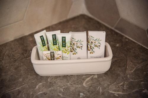 a container filled with books sitting on a counter at Iolanda Vacanze in Lucugnano