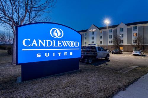 a sign for a hotel in front of a building at Candlewood Suites Lincoln by IHG in Lincoln