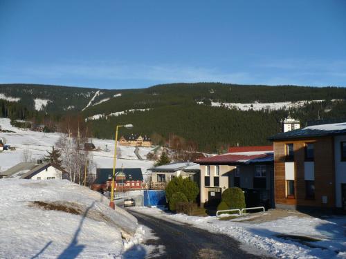a small town in the snow with a mountain at Ubytování Zmatlíková in Pec pod Sněžkou