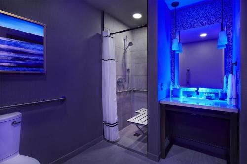 a bathroom with a shower and a toilet and a sink at InterContinental Minneapolis - St. Paul Airport by IHG in Minneapolis