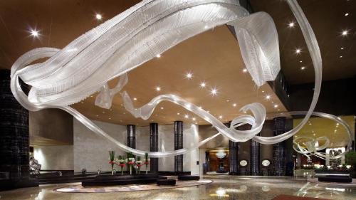a large white object hanging from the ceiling in a building at InterContinental Shanghai Jing' An by IHG in Shanghai