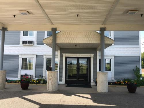 a building with a door in front of it at Americas Best Value Inn - Gaylord in Gaylord