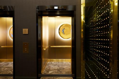 two elevators in a building with a glass door at Kimpton Saint George Hotel by IHG in Toronto