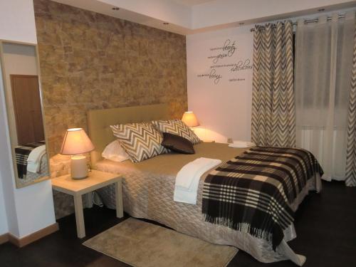a bedroom with a bed and a brick wall at Retiro da Estrela in Seia