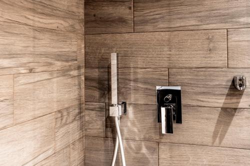 a shower with a cord plugged into a wall at Bella Roe Premium Apartments in Belgrade